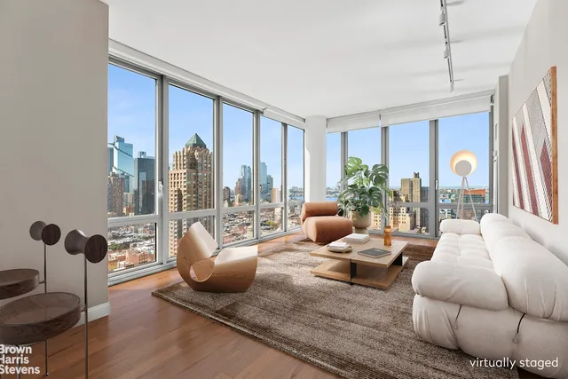 a living room with furniture and a floor to ceiling window