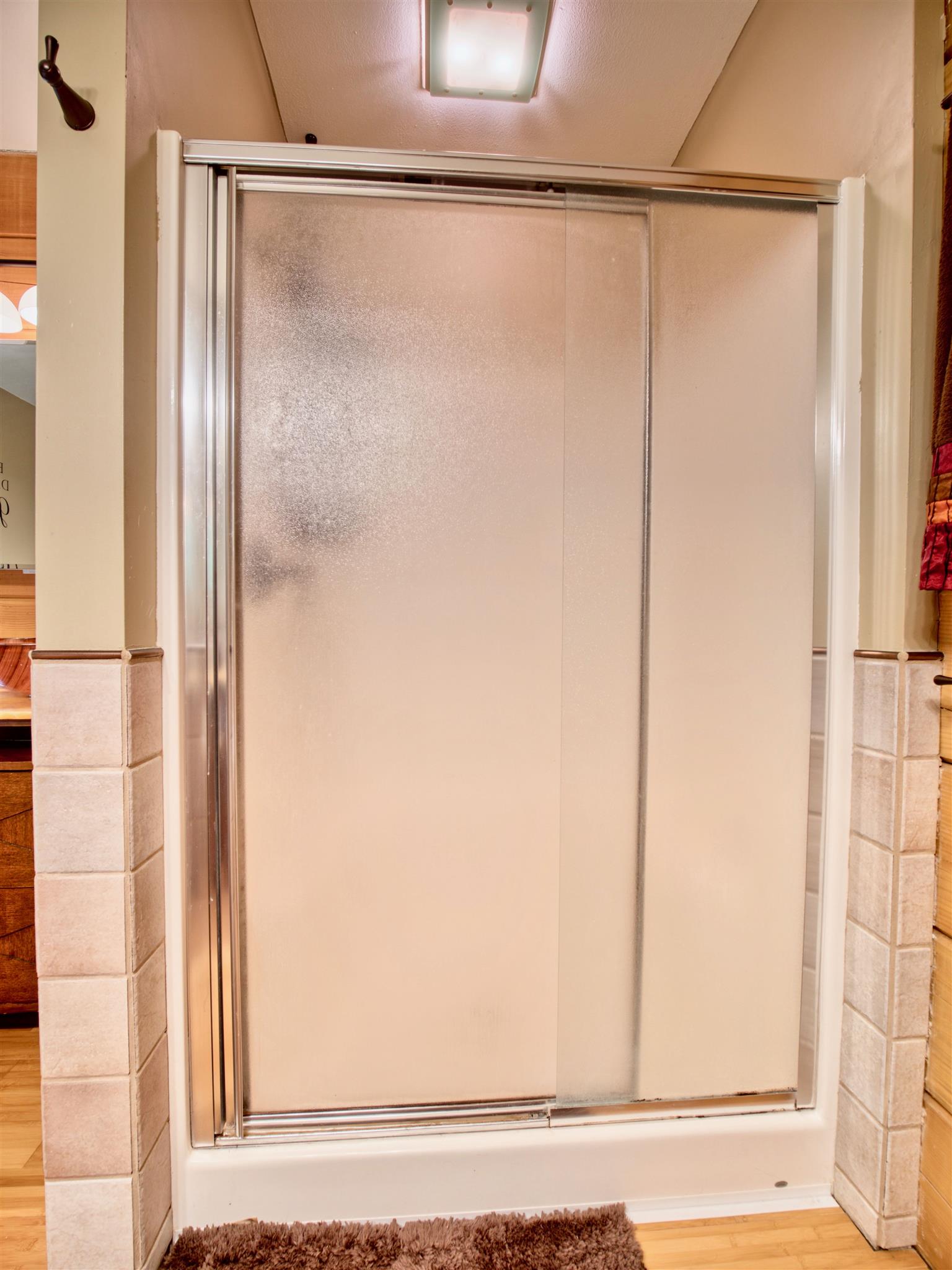 328 Charles Smith Road Lascassas, TN 37085 - Photo 13 of 26 a bathroom with a glass shower door and a window