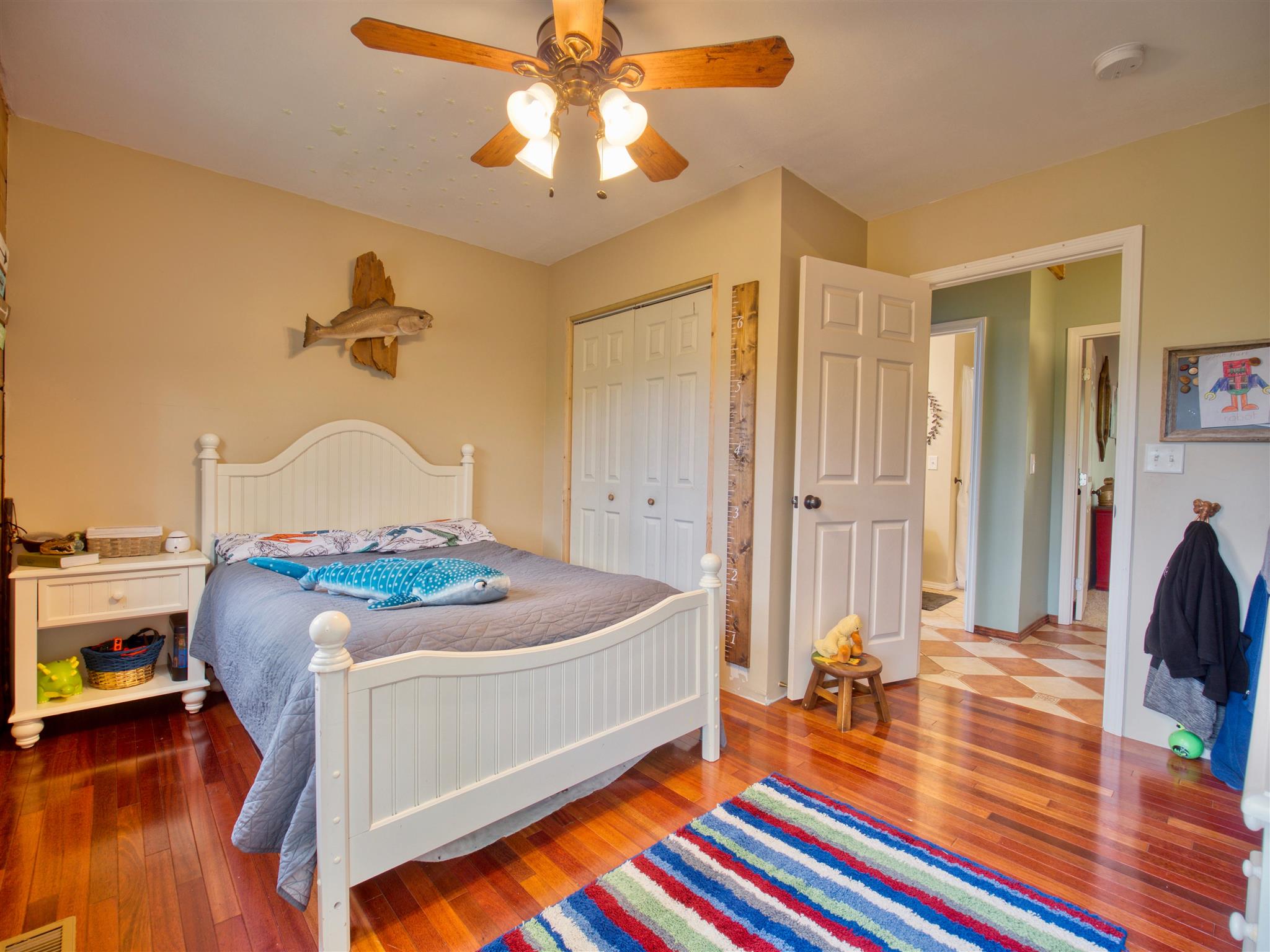 328 Charles Smith Road Lascassas, TN 37085 - Photo 15 of 26 a bedroom with a bed and a chandelier