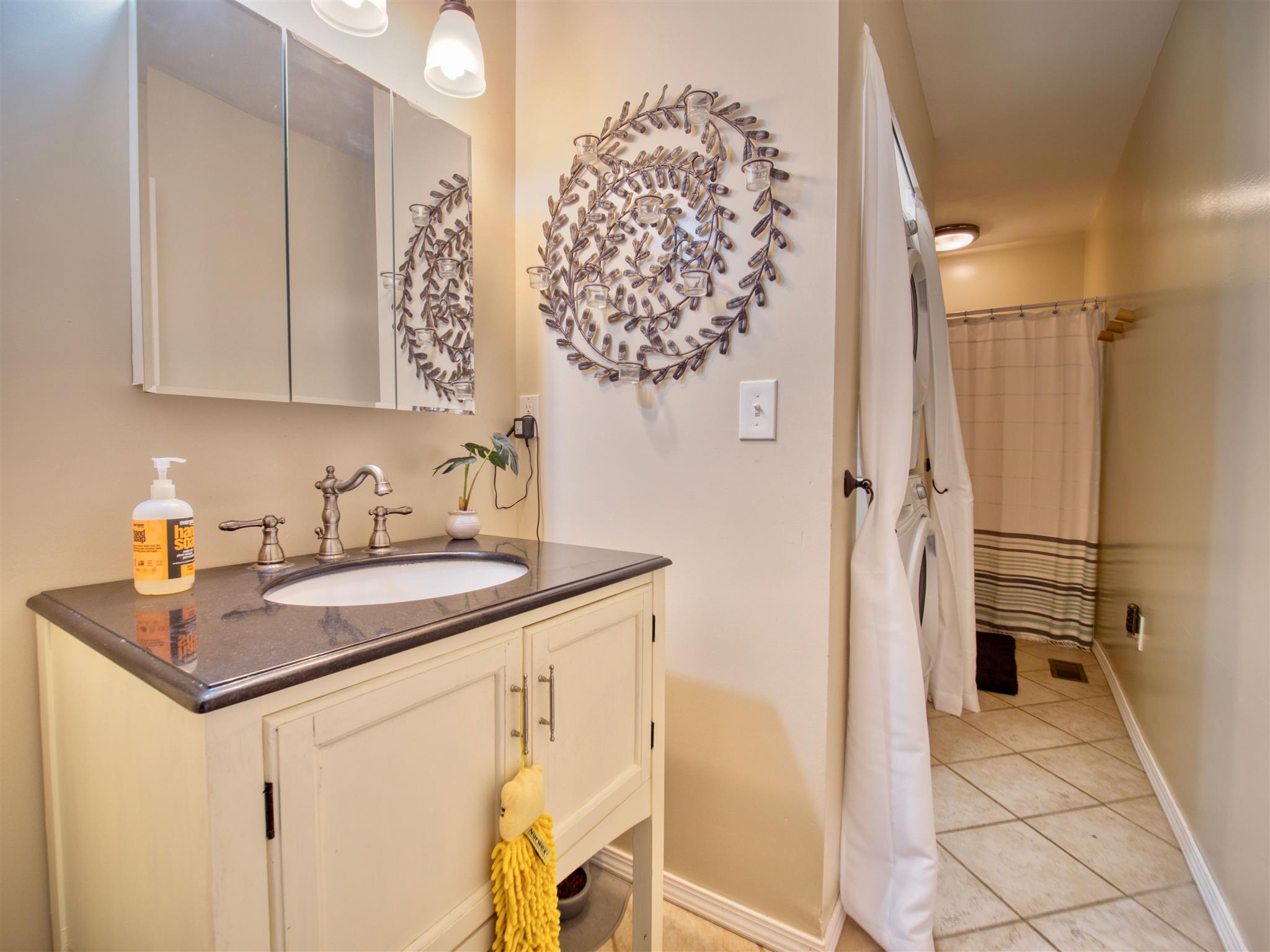 328 Charles Smith Road Lascassas, TN 37085 - Photo 16 of 26 a bathroom with a granite countertop sink a mirror and shower