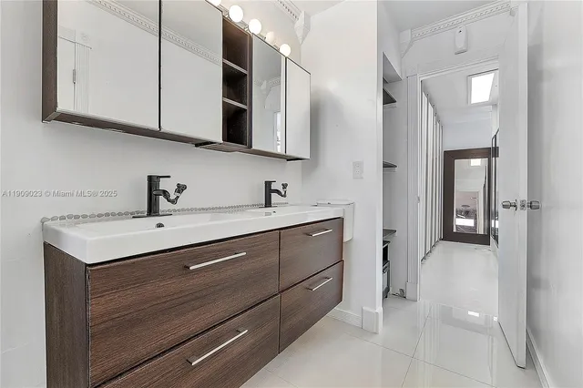 a spacious bathroom with a sink and a mirror