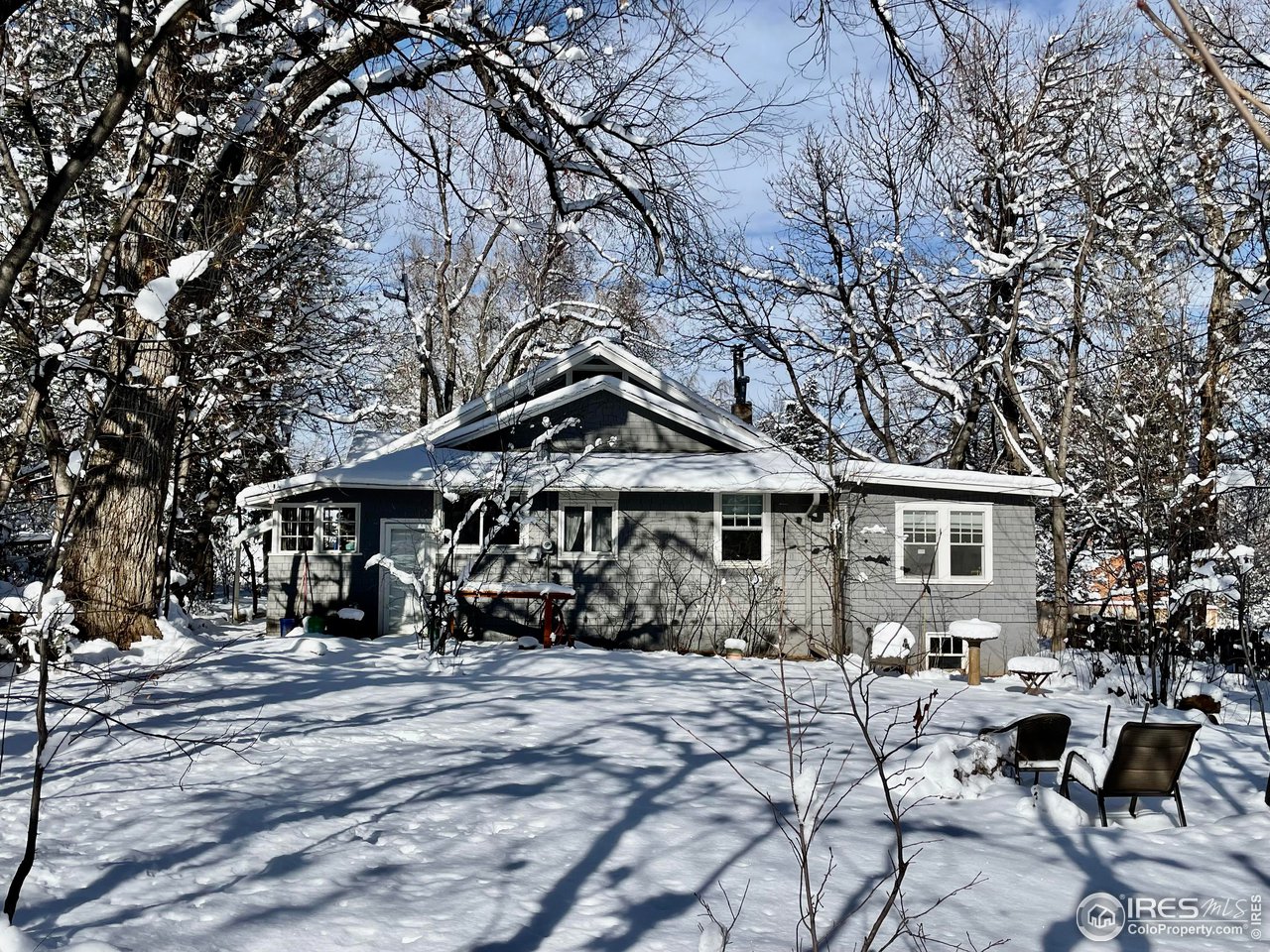 1520 Baseline Road Boulder, CO 80302 - Photo 16 of 29 a front view of a house with a yard covered in snow