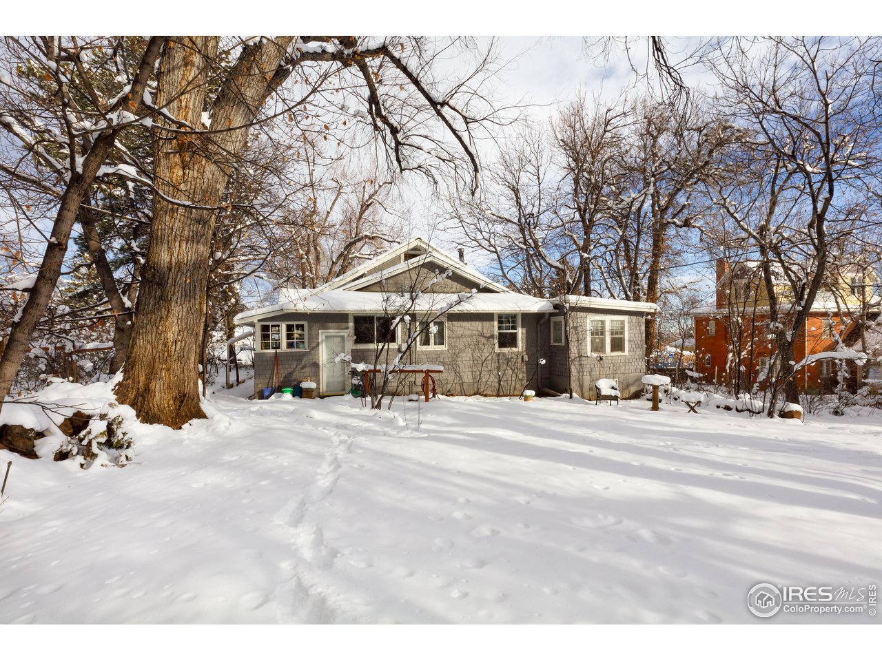 1520 Baseline Road Boulder, CO 80302 - Photo 5 of 29 a wooden bench sitting in front of a building