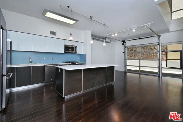 a kitchen with stainless steel appliances granite countertop a stove and a refrigerator