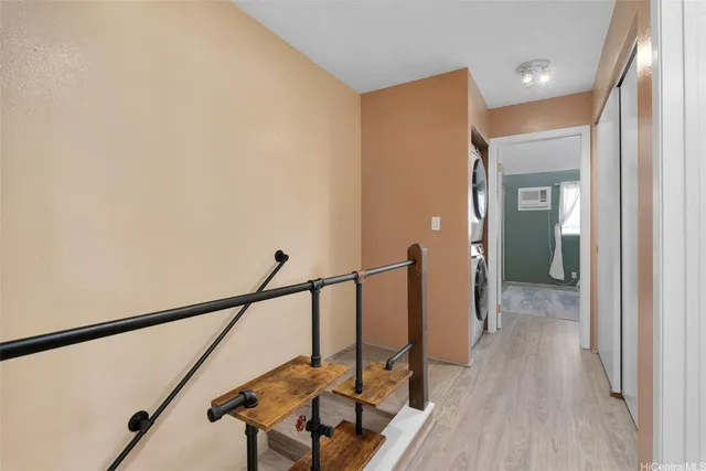 a view of a hallway with wooden floor and staircase