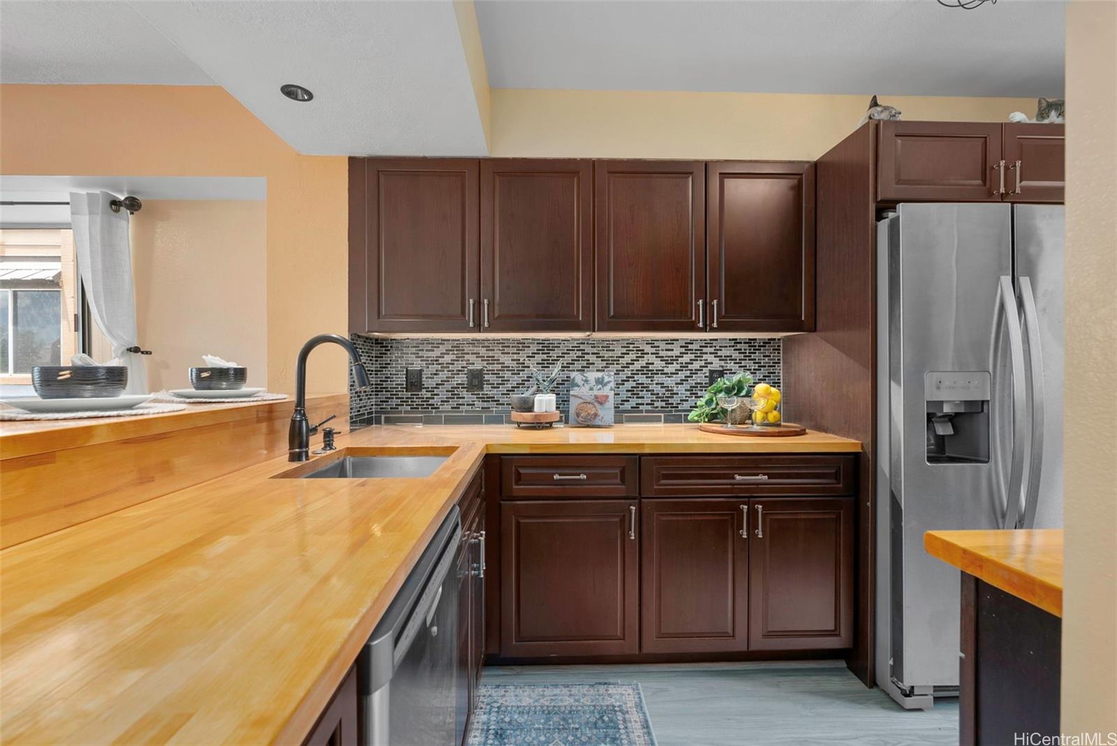 98-941 Moanalua Road, Unit 402 Aiea, HI 96701 - Photo 4 of 22 a kitchen with stainless steel appliances granite countertop a refrigerator and a sink