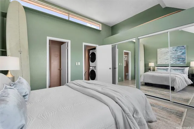 a bedroom with a large bed and a mirror