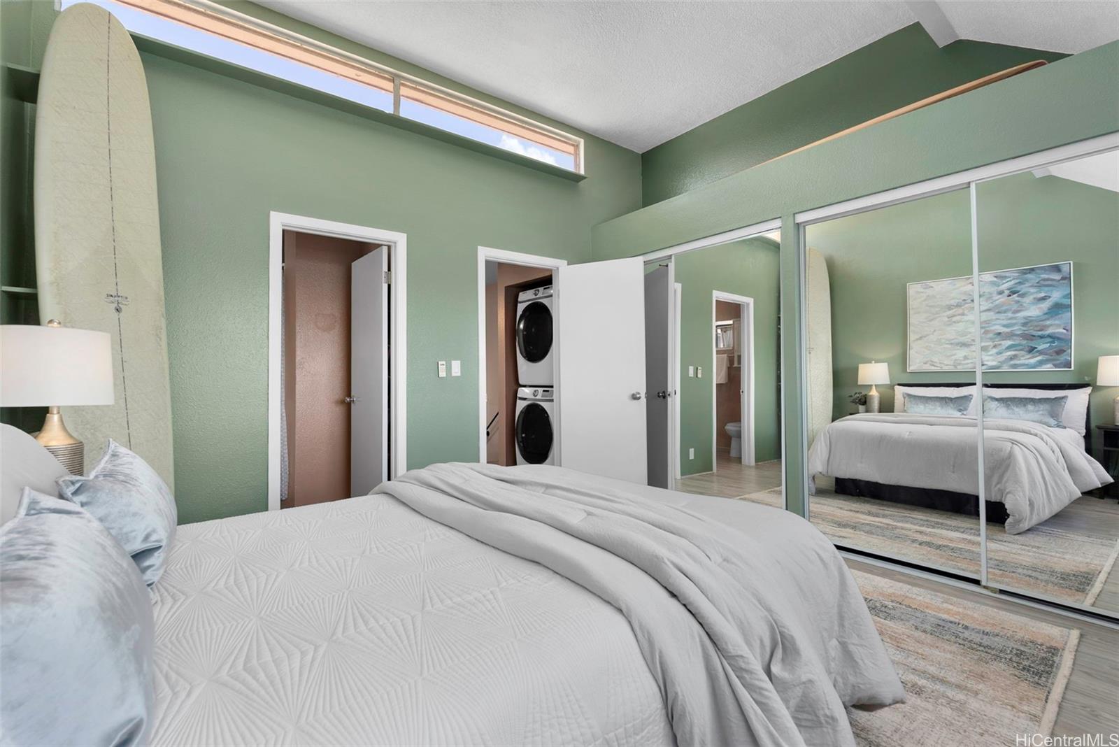 98-941 Moanalua Road, Unit 402 Aiea, HI 96701 - Photo 7 of 22 a bedroom with a large bed and a mirror