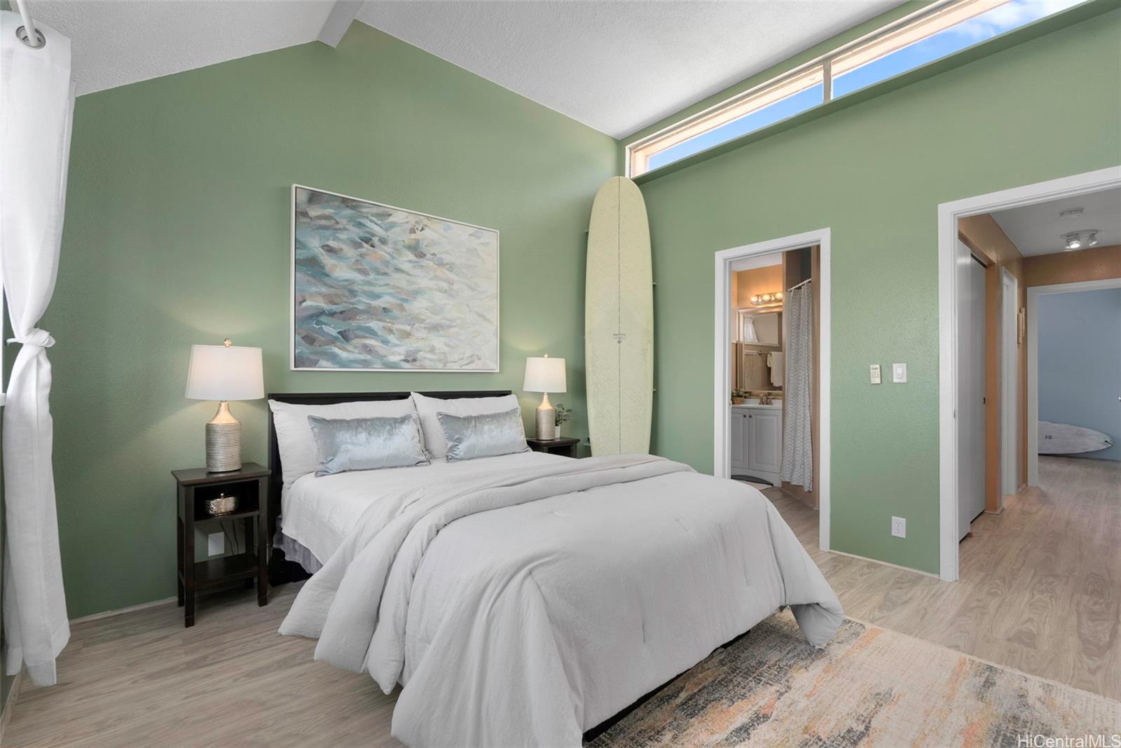 98-941 Moanalua Road, Unit 402 Aiea, HI 96701 - Photo 8 of 22 a bedroom with a bed and a painting on the wall