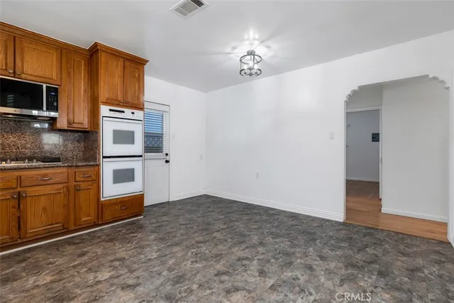 a kitchen with stainless steel appliances a refrigerator and microwave