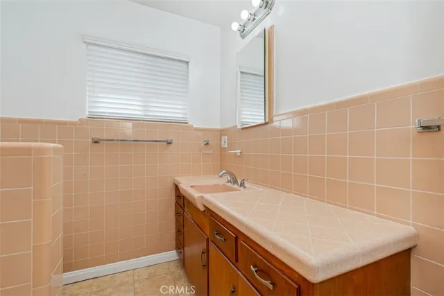 a bathroom with a sink a vanity and a shower