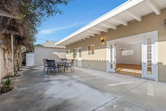 a view of a porch with table and chairs and potted plants