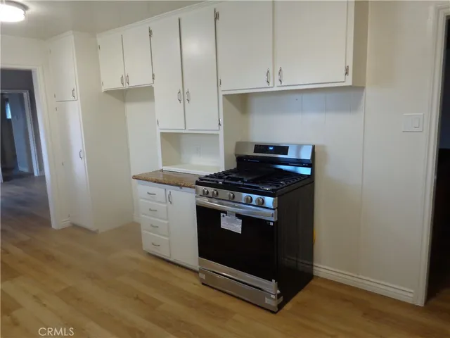 a stove top oven sitting inside of a kitchen
