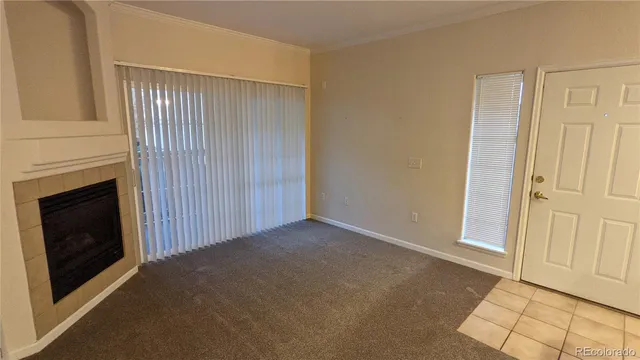 a view of a livingroom with an empty space and a fireplace