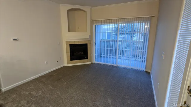 a view of empty room with windows and fireplace