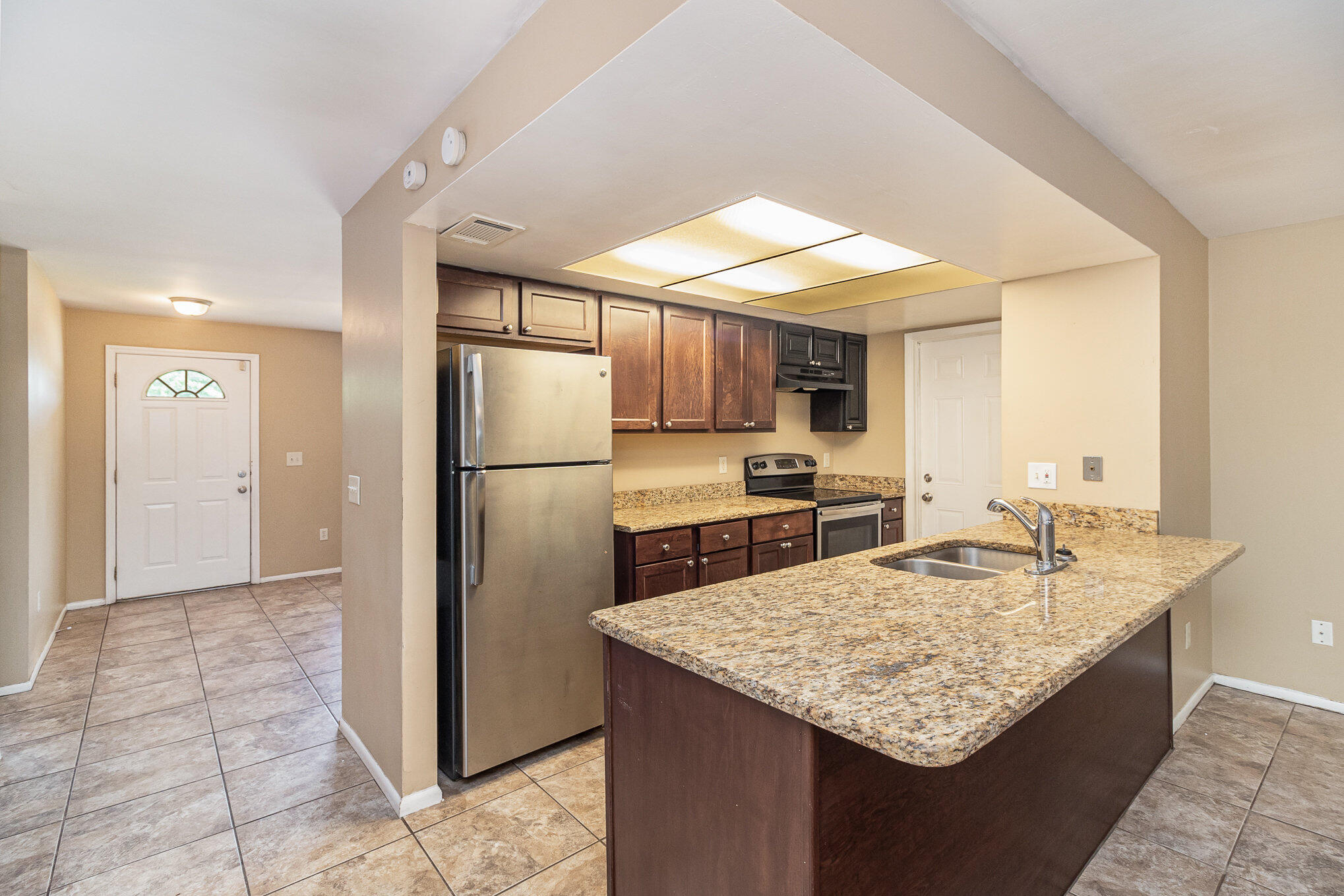 635 Croton Road Melbourne, FL 32935 - Photo 8 of 22 a kitchen with refrigerator and kitchen island