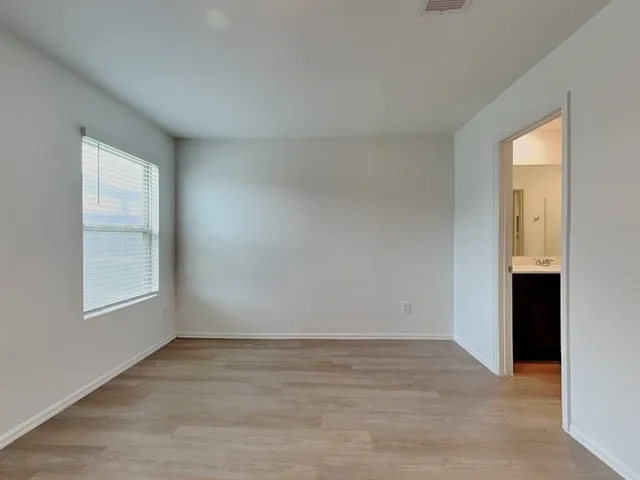 an empty room with windows and closet