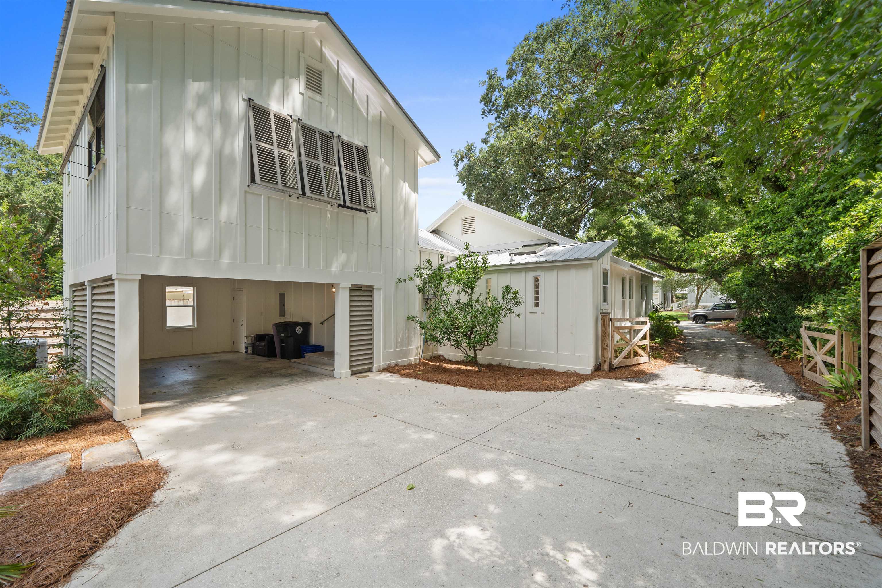 106 White Avenue Fairhope, AL 36532 - Photo 29 of 35 View of home's exterior with board and batten siding, driveway, and an attached garage