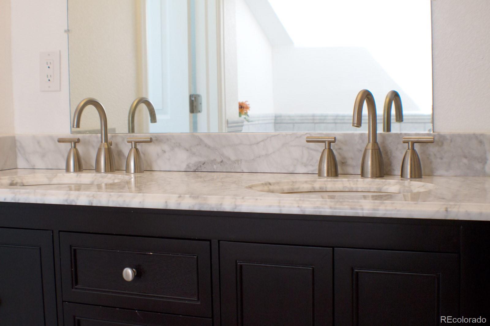 3596 South Telluride Way Aurora, CO 80013 - Photo 15 of 17 a sink with granite countertop a sink and cabinets