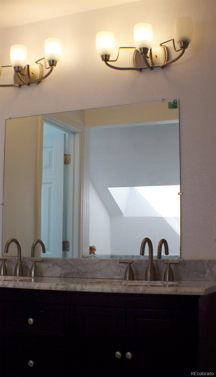 3596 South Telluride Way Aurora, CO 80013 - Photo 16 of 17 a bathroom with a sink and a mirror