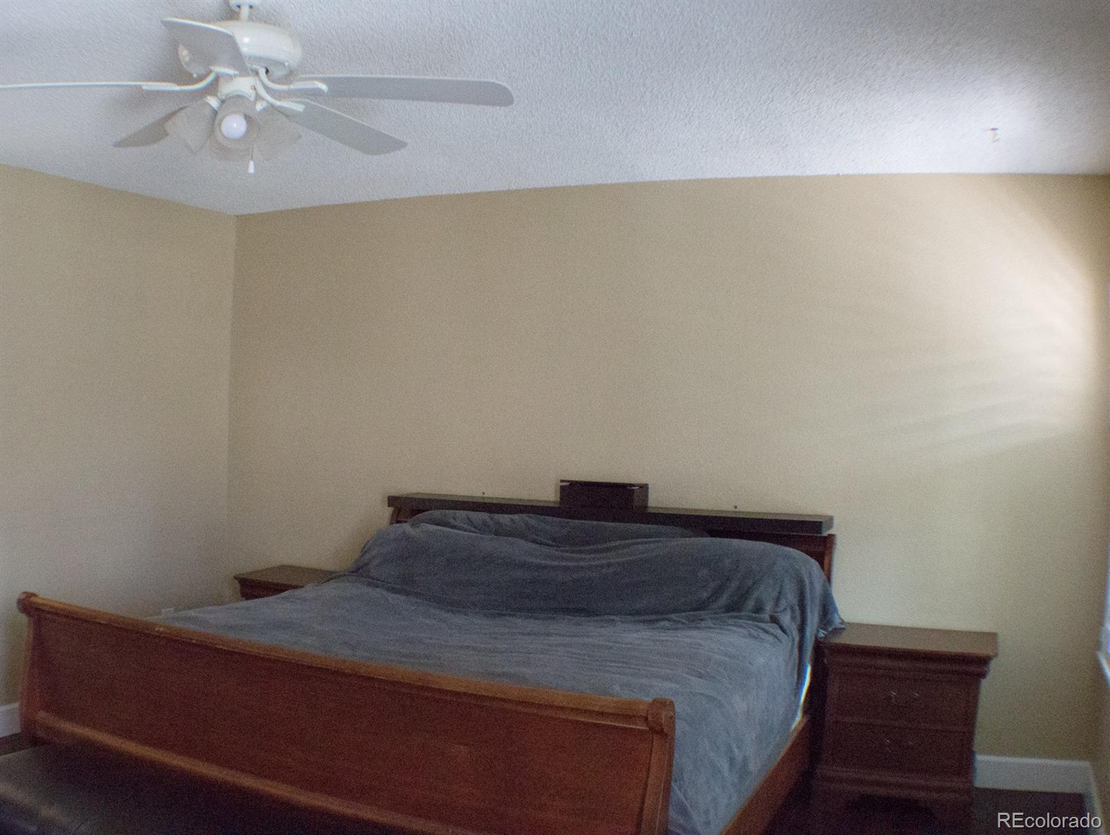 3596 South Telluride Way Aurora, CO 80013 - Photo 17 of 17 a bedroom with a bed and a chandelier fan
