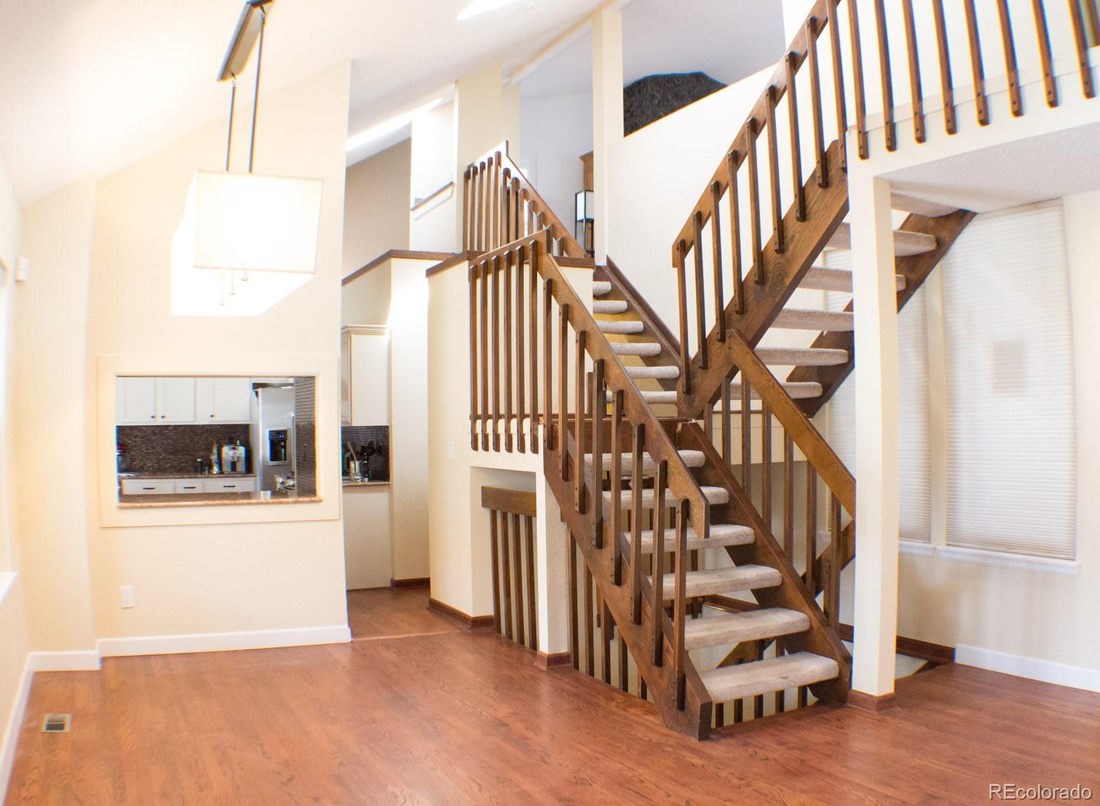 3596 South Telluride Way Aurora, CO 80013 - Photo 7 of 17 a view of entryway with stairs and wooden floor