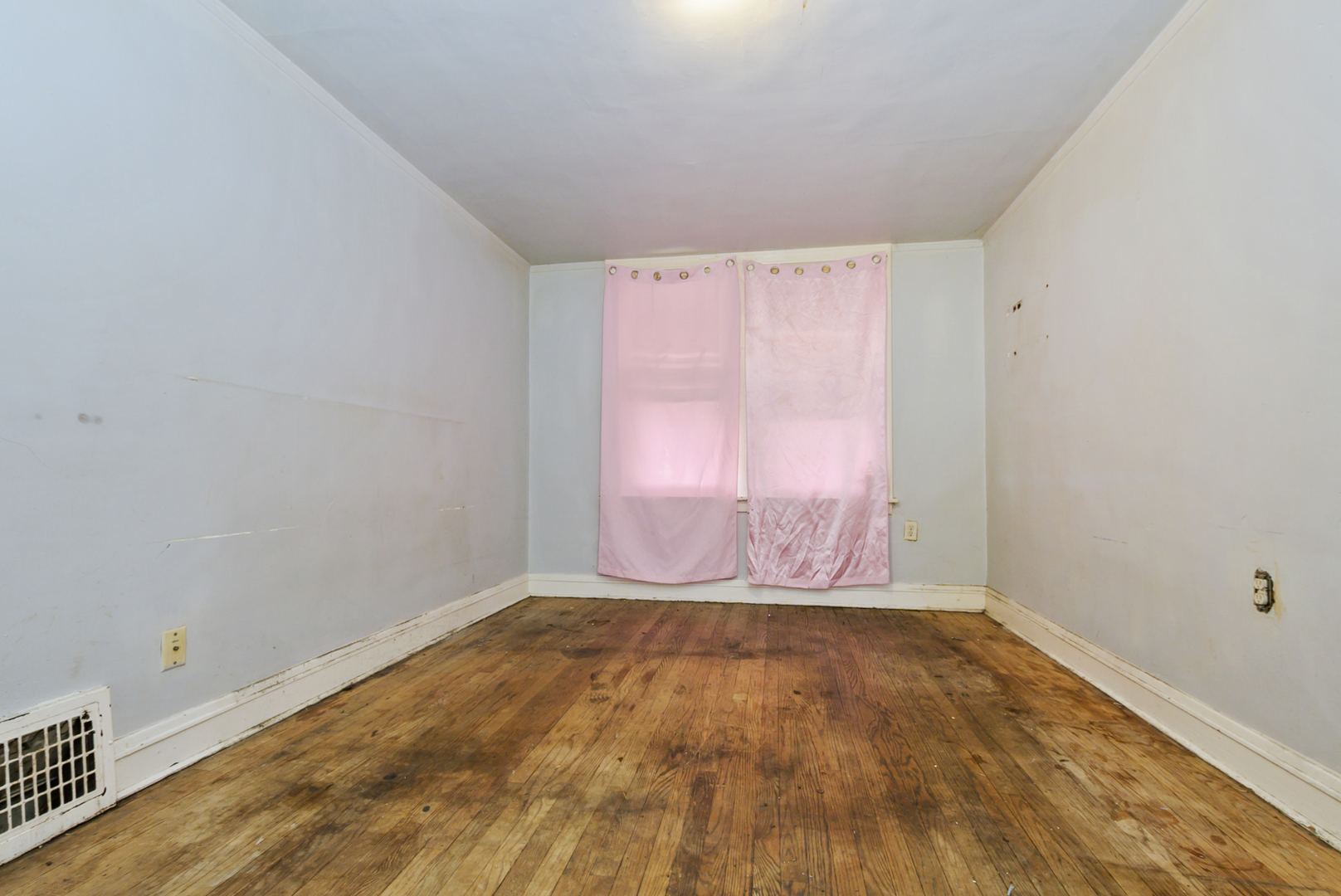 10320 South Indiana Avenue Chicago, IL 60628 - Photo 12 of 24 a view of an empty room with wooden floor and a window