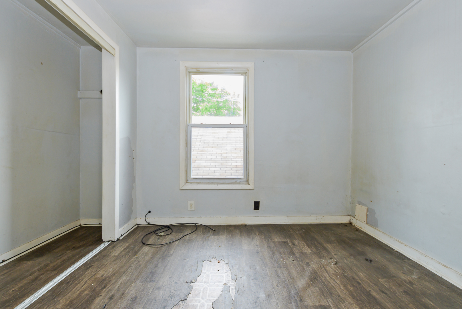 10320 South Indiana Avenue Chicago, IL 60628 - Photo 13 of 24 an empty room with wooden floor and windows