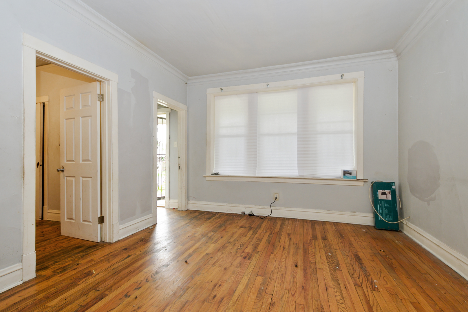 10320 South Indiana Avenue Chicago, IL 60628 - Photo 2 of 24 a view of empty room with wooden floor and fan