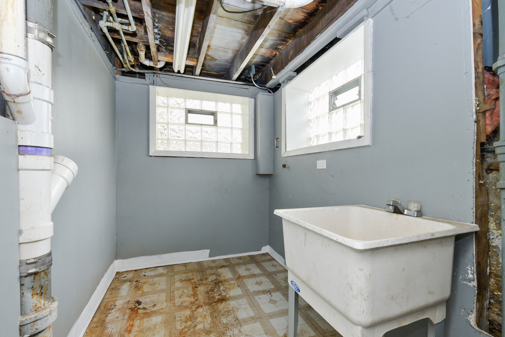 10320 South Indiana Avenue Chicago, IL 60628 - Photo 22 of 24 a bathroom with a sink a window and a mirror