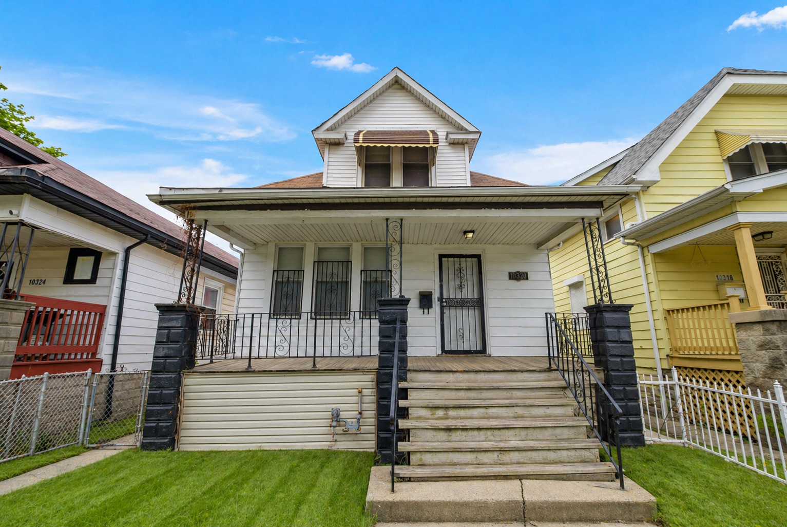 10320 South Indiana Avenue Chicago, IL 60628 - Photo 24 of 24 a front view of a house with a yard