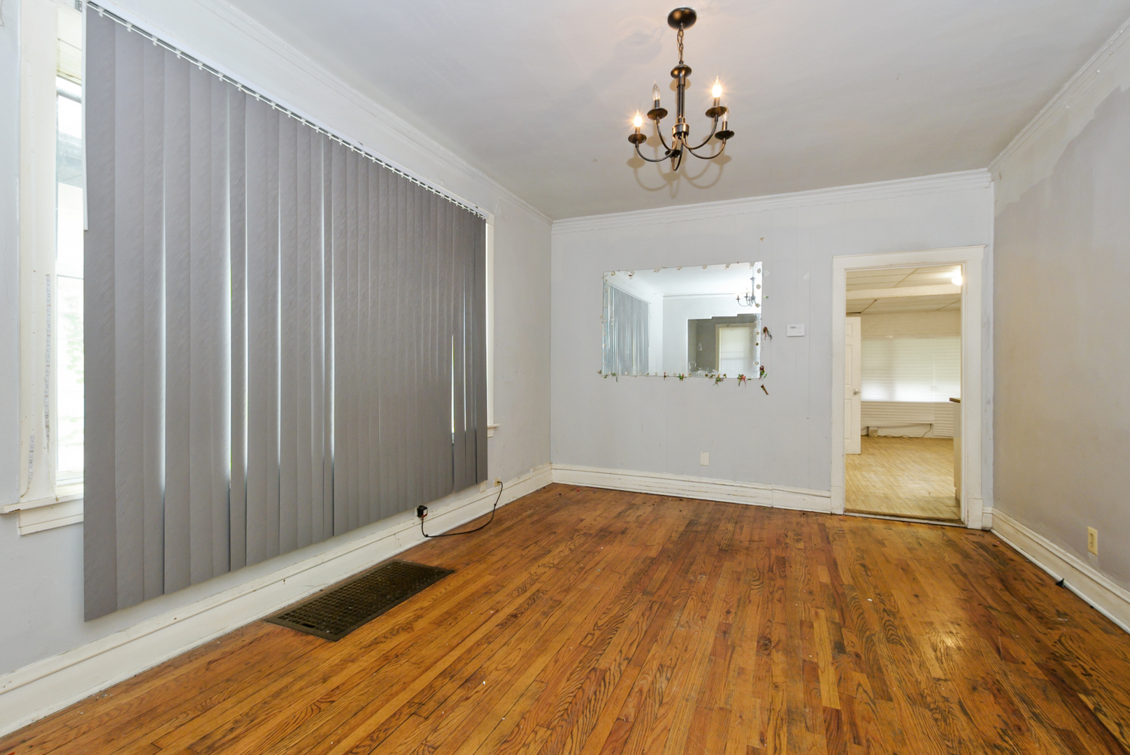 10320 South Indiana Avenue Chicago, IL 60628 - Photo 3 of 24 a view of a room with wooden floor and staircase