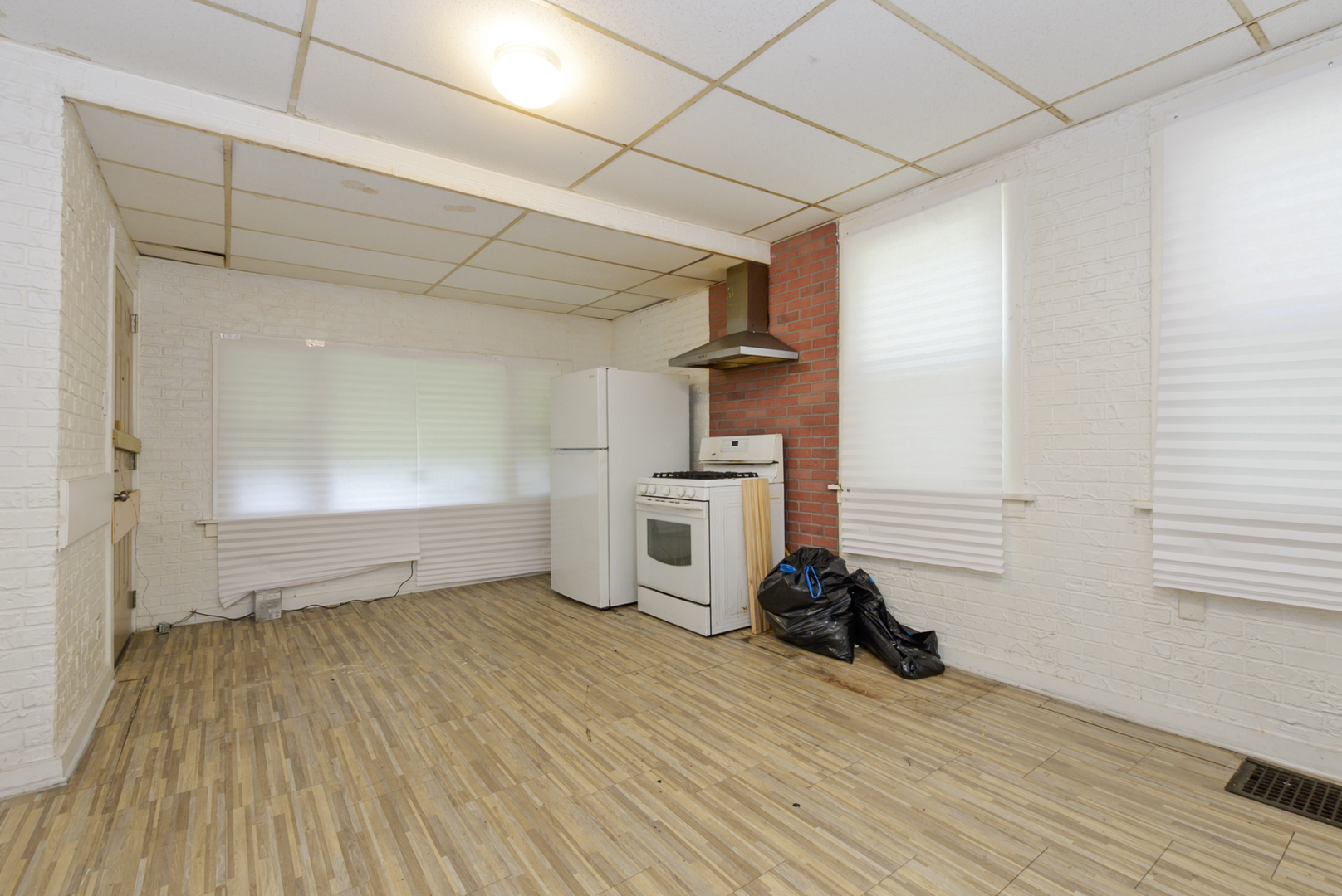 10320 South Indiana Avenue Chicago, IL 60628 - Photo 4 of 24 a view of a room with wooden floor and a window