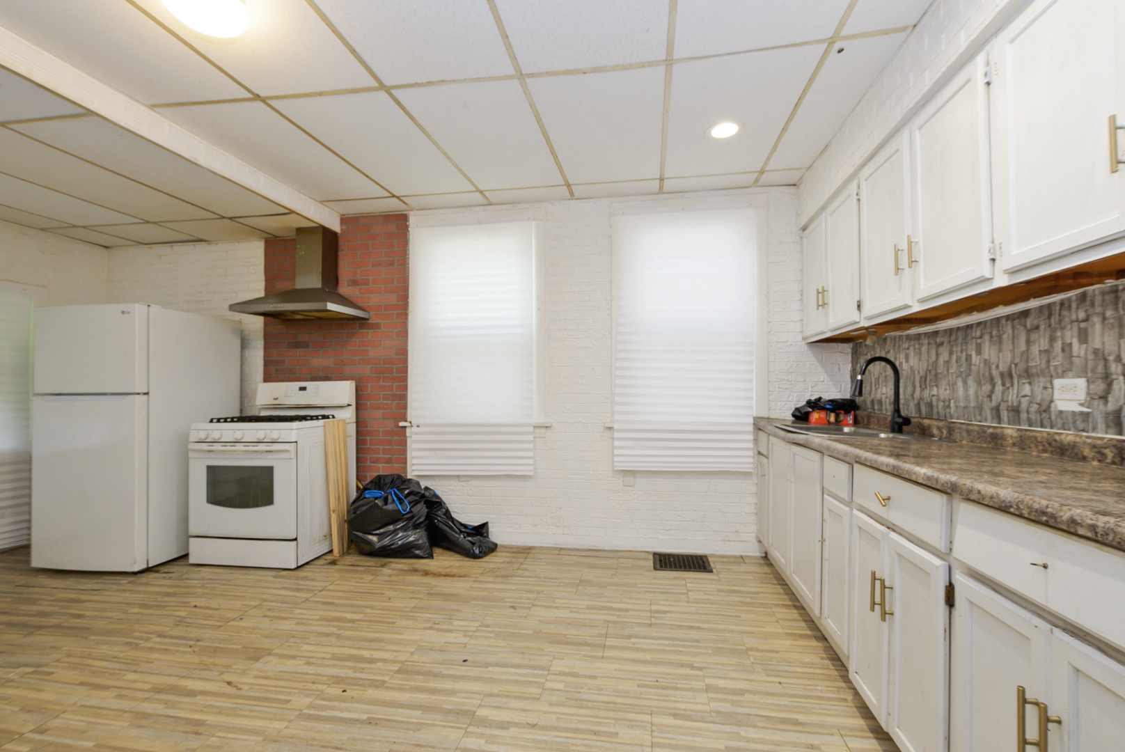 10320 South Indiana Avenue Chicago, IL 60628 - Photo 5 of 24 a kitchen with a sink and cabinets