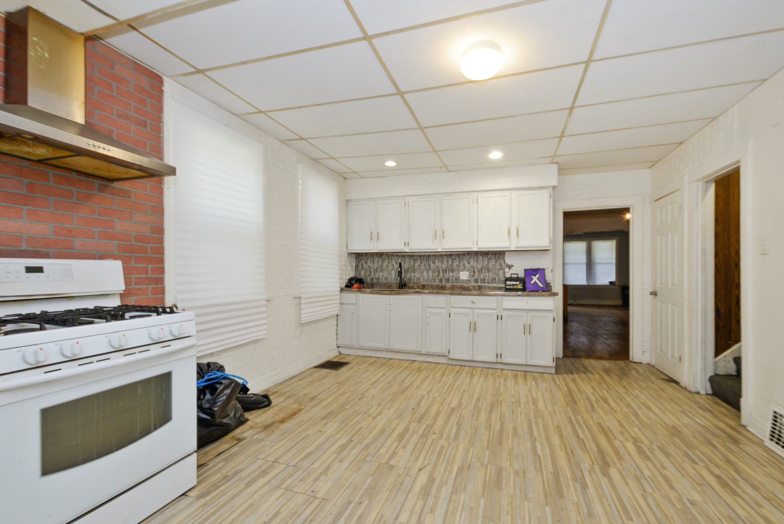 10320 South Indiana Avenue Chicago, IL 60628 - Photo 6 of 24 a kitchen with stainless steel appliances granite countertop a stove a sink and a refrigerator