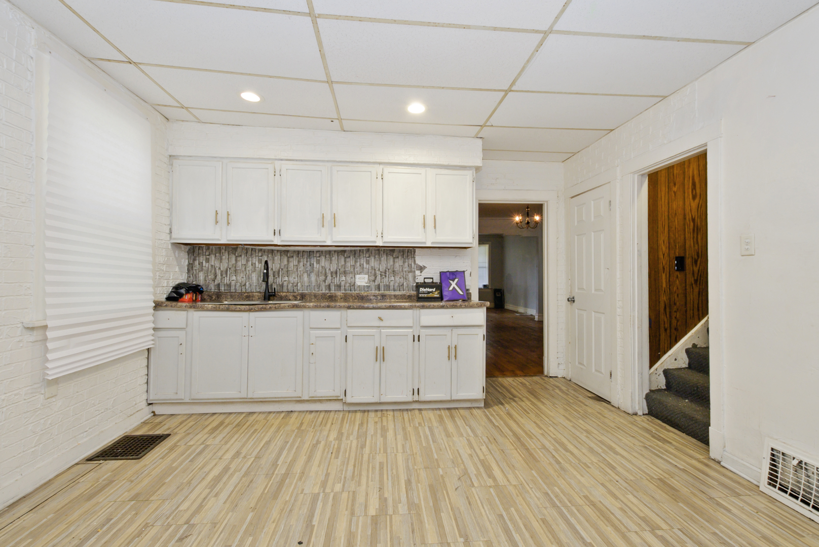 10320 South Indiana Avenue Chicago, IL 60628 - Photo 7 of 24 a kitchen with granite countertop white cabinets and white appliances