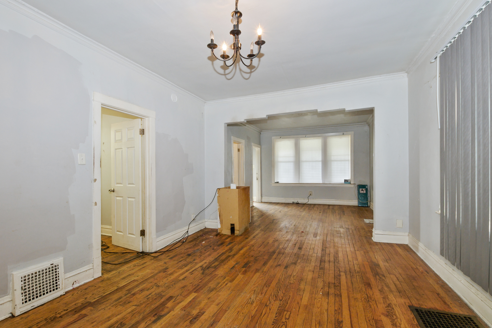 10320 South Indiana Avenue Chicago, IL 60628 - Photo 9 of 24 a view of a room with wooden floor and window