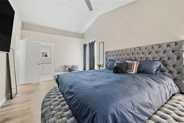 a bed sitting in a bedroom and dresser