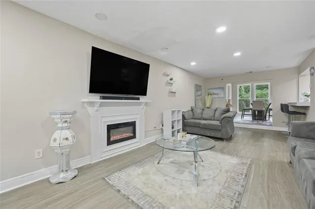 a living room with furniture a fireplace and a flat screen tv