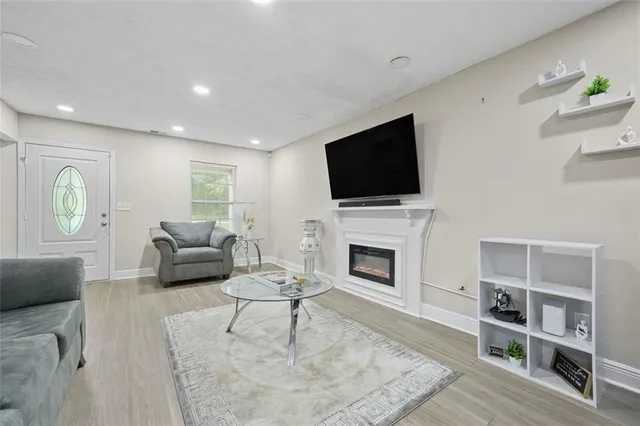 a living room with furniture a fireplace and a flat screen tv