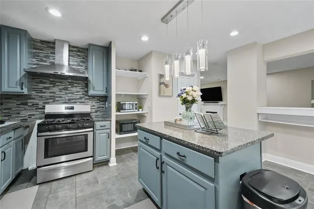 a kitchen with a sink stove and cabinets