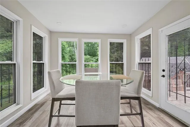 a view of a dining room with furniture large windows and wooden floor