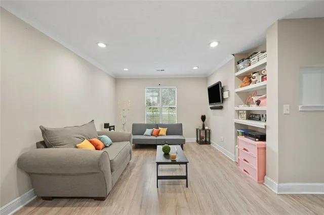 a living room with furniture wooden floor and window