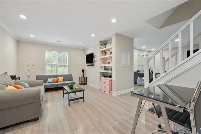 a living room with furniture and a wooden floor