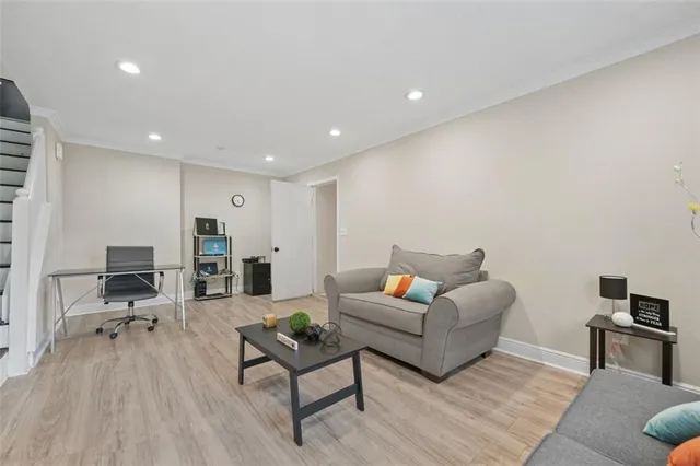 a living room with furniture and a wooden floor
