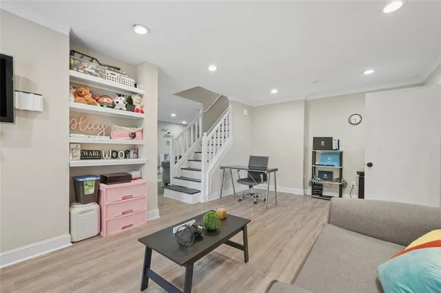 a living room with furniture and wooden floor