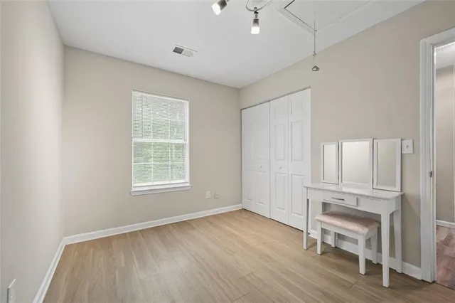 an empty room with wooden floor and window