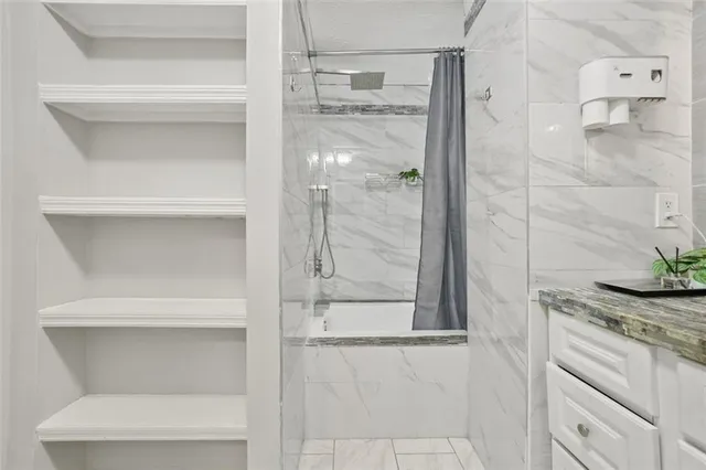 a bathroom with a granite countertop shower