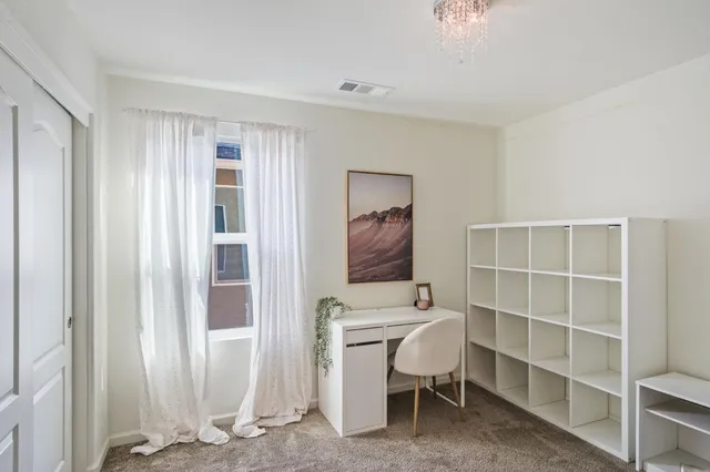 a view of a livingroom with furniture and a window
