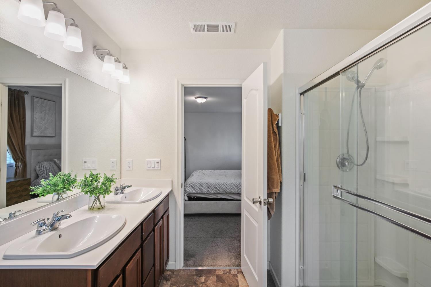 767 Day Break Way Ceres, CA 95307 - Photo 22 of 28 a en suite bathroom with a granite countertop sink and a mirror